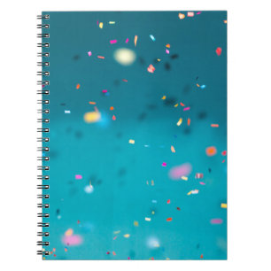 Selective focus photography of multicolored confet notebook