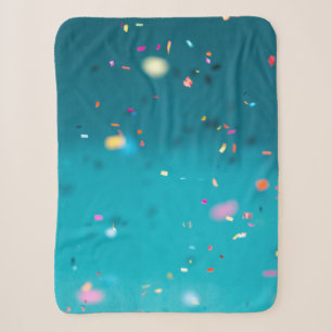 Selective focus photography of multicolored confet sherpa blanket