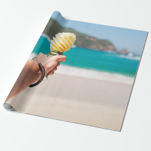 Selective focus photography of person holding frui wrapping paper