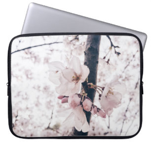 SELECTIVE FOCUS PHOTOGRAPHY OF WHITE AND PINK PETA LAPTOP SLEEVE