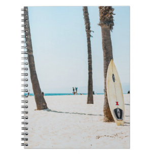 Selective focus photography of white surfboard notebook