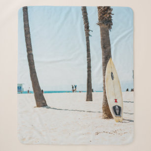 Selective focus photography of white surfboard sherpa blanket