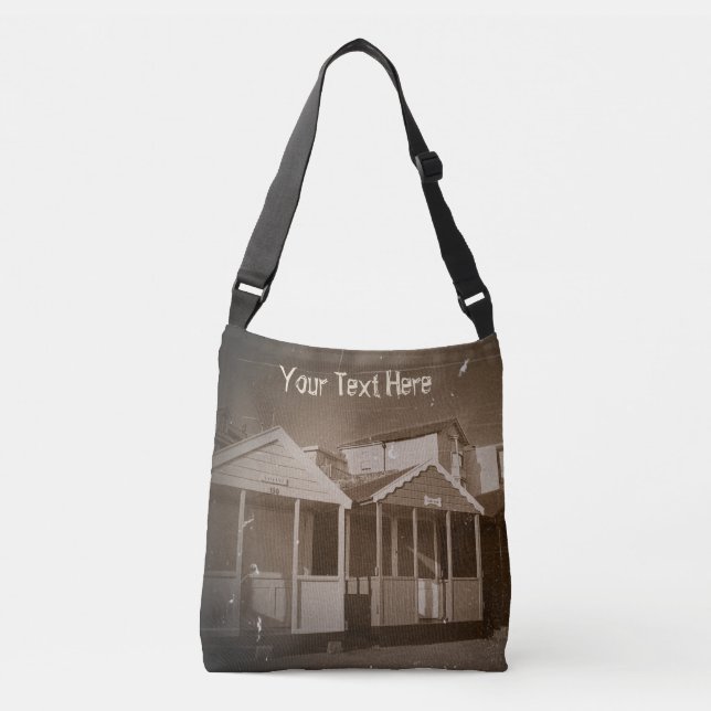 sepia pic of beach huts blue skies english seaside crossbody bag (Front)