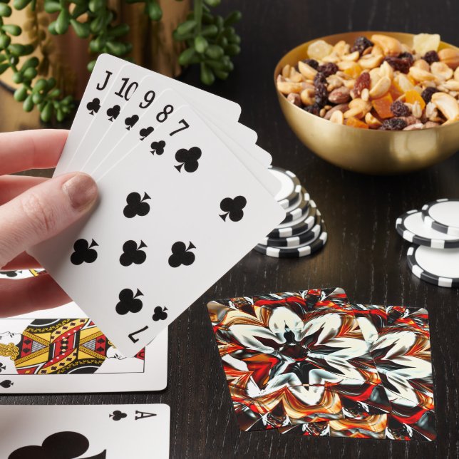 Sepia to white flower surrounded by reddish golden playing cards (In Situ)