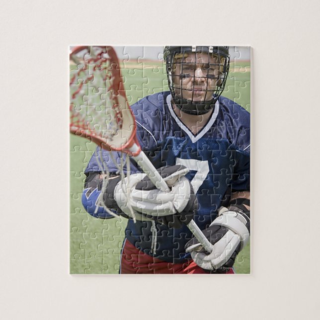 Serious lacrosse player holding crosse jigsaw puzzle (Vertical)