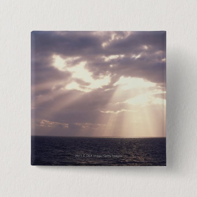 Setting sun shining through clouds over ocean 15 cm square badge (Front)