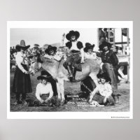 Seven rodeo cowgirls jokingly posing with a donkey