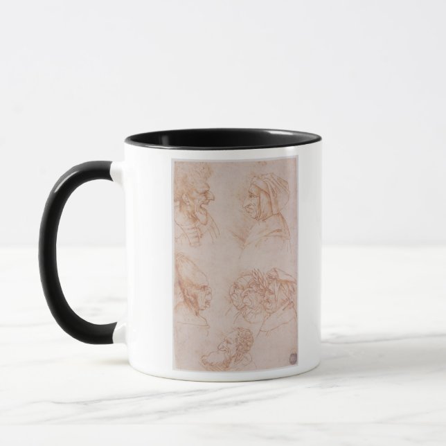Seven Studies of Grotesque Faces (red chalk on pap Mug (Left)
