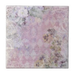 Shabby Vintage Floral Tile<br><div class="desc">Pretty design in a lightly distressed shabby collage style featuring lace mesh,  pansies and asst. flowers,  and an off-white engraved scroll border on a harlequin diamond background with subtle antique handwritten text in shades of lilac,  rose and grey.</div>