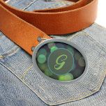 Shades of green circles and monogram belt buckle<br><div class="desc">The shades of green circles on a dark background and the elegant monogram make this a stylish belt buckle. The pattern is reminiscent of intentionally blurred photography. Change the initial to your own to personalise this fashion accessory.</div>