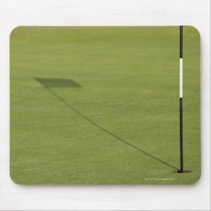 shadow of golf flag on golf course green mouse pad