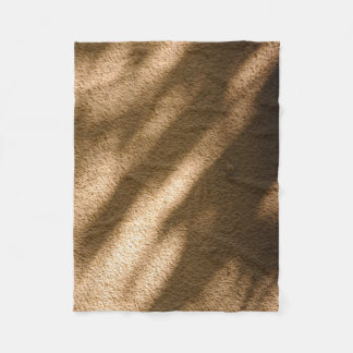 Shadow on brown carpeted floor fleece blanket