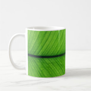 Shallow focus photo of green leaf coffee mug