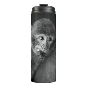 SHALLOW FOCUS PHOTOGRAPHY OF BLACK MONKEY THERMAL TUMBLER