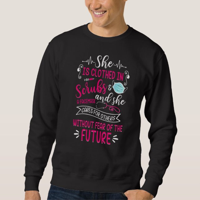 She Is Clothed In Scrubs & Facemask Proud Nurse Nu Sweatshirt (Front)