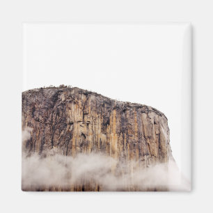 Sheer cliff rising above clouds magnet