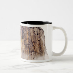 Sheer cliff rising above clouds Two-Tone coffee mug