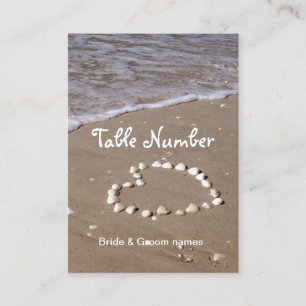 Shell heart on sandy beach reception place cards