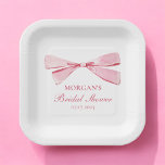 She's Tying The Knot Pink Bow Bridal Shower Paper Plate<br><div class="desc">Celebrate the bride-to-be with our "She's Tying The Knot" Pink Bridal Shower Paper Plates. Featuring a beautiful blush pink background with elegant script and a charming bow design, these plates add a sophisticated touch to your bridal shower decor. Made from high-quality, durable paper, they are perfect for serving appetizers, desserts,...</div>