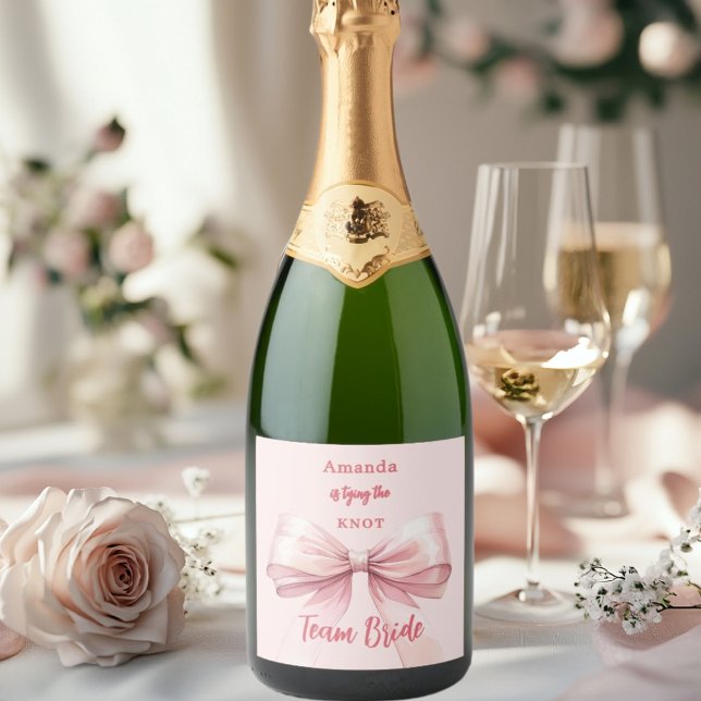 She's tying the knot pink bow Team Bride Sparkling Wine Label (Creator Uploaded)