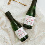 She's Tying The Knot Red Elegant Hand Drawn Bow Sparkling Wine Label<br><div class="desc">The "She's Tying the Knot Red Elegant Hand Drawn Bow" collection is a timeless celebration of love and elegance. Centred around a delicate, hand-drawn bow, this suite combines refined typography with a bold red palette, creating a striking and sophisticated aesthetic. Perfect for a bridal shower steeped in charm and grace,...</div>