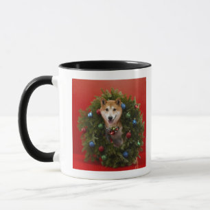Shiba Inu dog sitting in Christmas wreath Mug