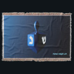 Shiny Blue Dreidel Throw Blanket<br><div class="desc">A modernistic,  metallic blue dreidel against a dark,  night-like background.  Two of the Hebrew letters found on a dreidel,  nun and shin,  glow brightly.  Hebrew text reading "Chag Chanukkah Sameach" (Happy Hanukkah) also appears in glowing blue and white.</div>