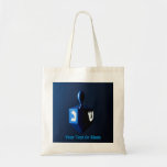 Shiny Blue Dreidel Tote Bag<br><div class="desc">A modernistic,  metallic blue dreidel against a dark,  night-like background.  Two of the Hebrew letters found on a dreidel,  nun and shin,  glow brightly.  Add your own text.</div>