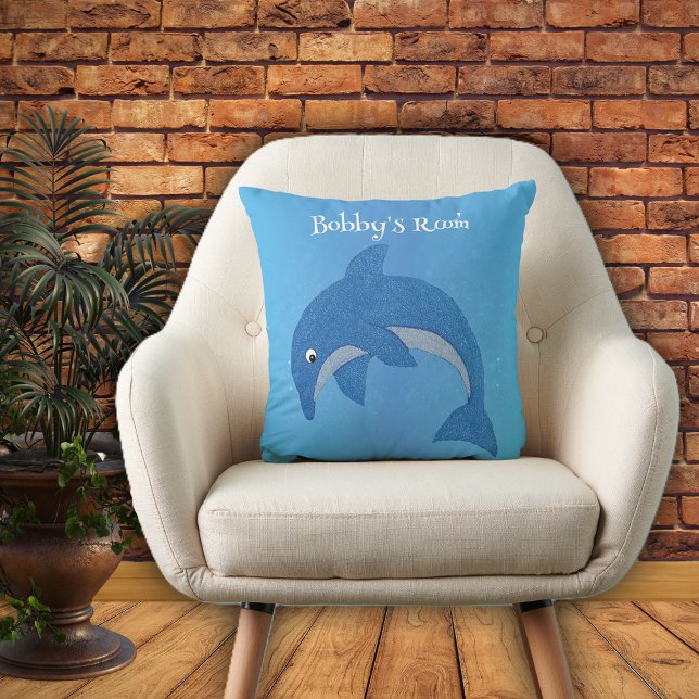 Shiny Cartoon Blue White Jumping Dolphin on Blue Cushion (Bright blue throw pillow with cute jumping dolphin in dark blue and white for kids bedroom.)