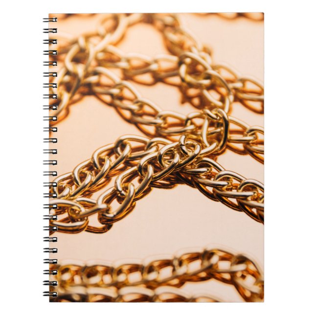 Shiny golden chains on reflective surface. Seamles Notebook (Front)