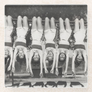 Showgirls on monkey bars, playful design. glass coaster