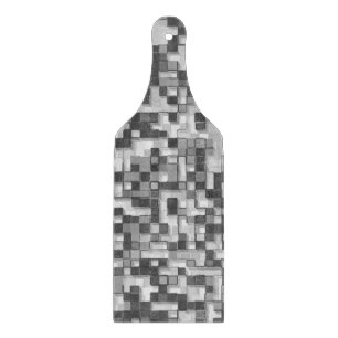 Shuffled small squares, tones of grey go to clear cutting board