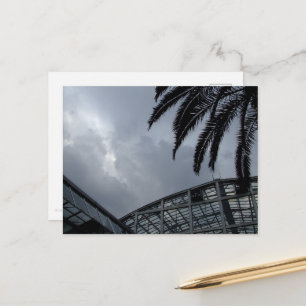 Silhouette of a greenhouse and a palm tree postcard