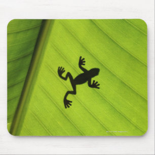 Silhouette of frog through banana leaf mouse pad