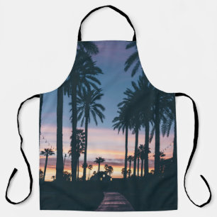 Silhouette of houses beside palm trees and pathway apron