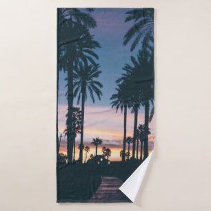 Silhouette of houses beside palm trees and pathway bath towel