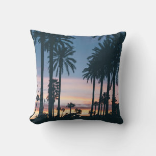 Silhouette of houses beside palm trees and pathway cushion