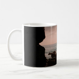 Silhouette of man in cave coffee mug