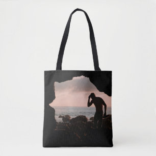 Silhouette of man in cave tote bag