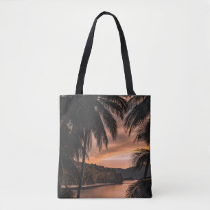 Silhouette of palm tree during golden hour tote bag