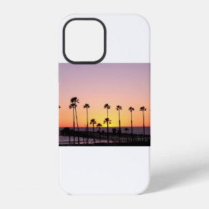 Silhouette of palm trees and dock during sunset iPhone 12 case