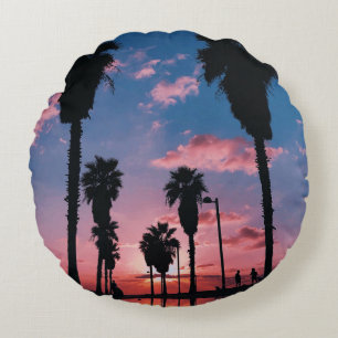 Silhouette of tree under cloudy sky round cushion