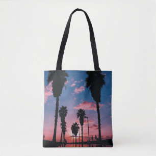 Silhouette of tree under cloudy sky tote bag