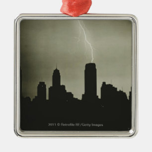 Silhouettes of skyscrapers and lightning in sky metal ornament