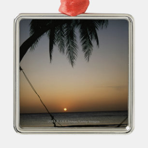 Silhuetted empty hammock at sunset metal ornament