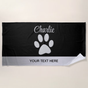 Silver Dog Paw on black background Beach Towel