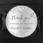 Silver glitter sparkles thank you wedding classic round sticker<br><div class="desc">Faux silver background,  decorated with faux glitter,  sparkles.  With the text: Thank you for sharing our special day,  with a small heart.   Personalise and add your names.</div>