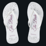 Silver Lace Cassis Purple The Bride White Wedding Thongs<br><div class="desc">Dance the night away with these beautiful wedding flip flops. Designed for the bride, they feature a simple yet elegant design with cassis purple, magenta, or berry coloured script lettering on a white background and fancy silver grey lace curls and swirls. Beautiful way to stay fancy and appropriate while giving...</div>
