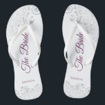 Silver Lace Cassis Purple The Bride White Wedding Thongs<br><div class="desc">Dance the night away with these beautiful wedding flip flops. Designed for the bride, they feature a simple yet elegant design with cassis purple, magenta, or berry coloured script lettering on a white background and fancy silver grey lace curls and swirls. Beautiful way to stay fancy and appropriate while giving...</div>