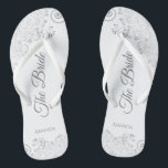 Silver Lace on White Elegant The Bride Wedding Thongs<br><div class="desc">Dance the night away with these beautiful wedding flip flops. Designed for the bride, they feature a simple yet elegant design with grey script lettering on a white background and fancy silver grey lace curls and swirls. Beautiful way to stay fancy and appropriate while giving your feet a break after...</div>